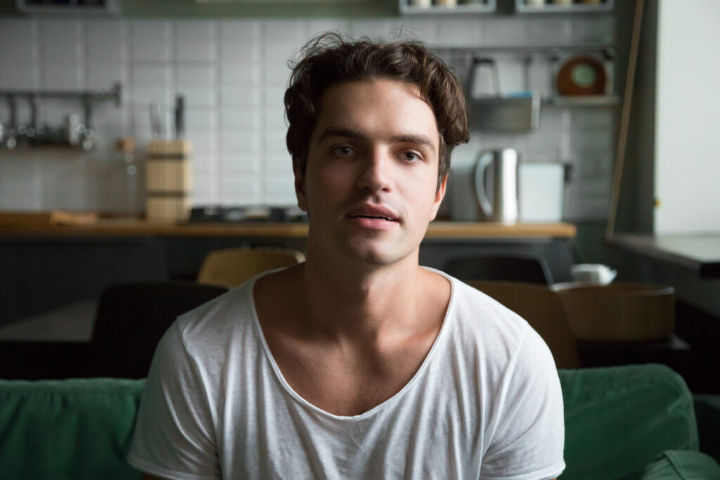 A young man sitting at home, listening
